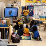 Students interacting with augmented reality at John Love Early Learning Center