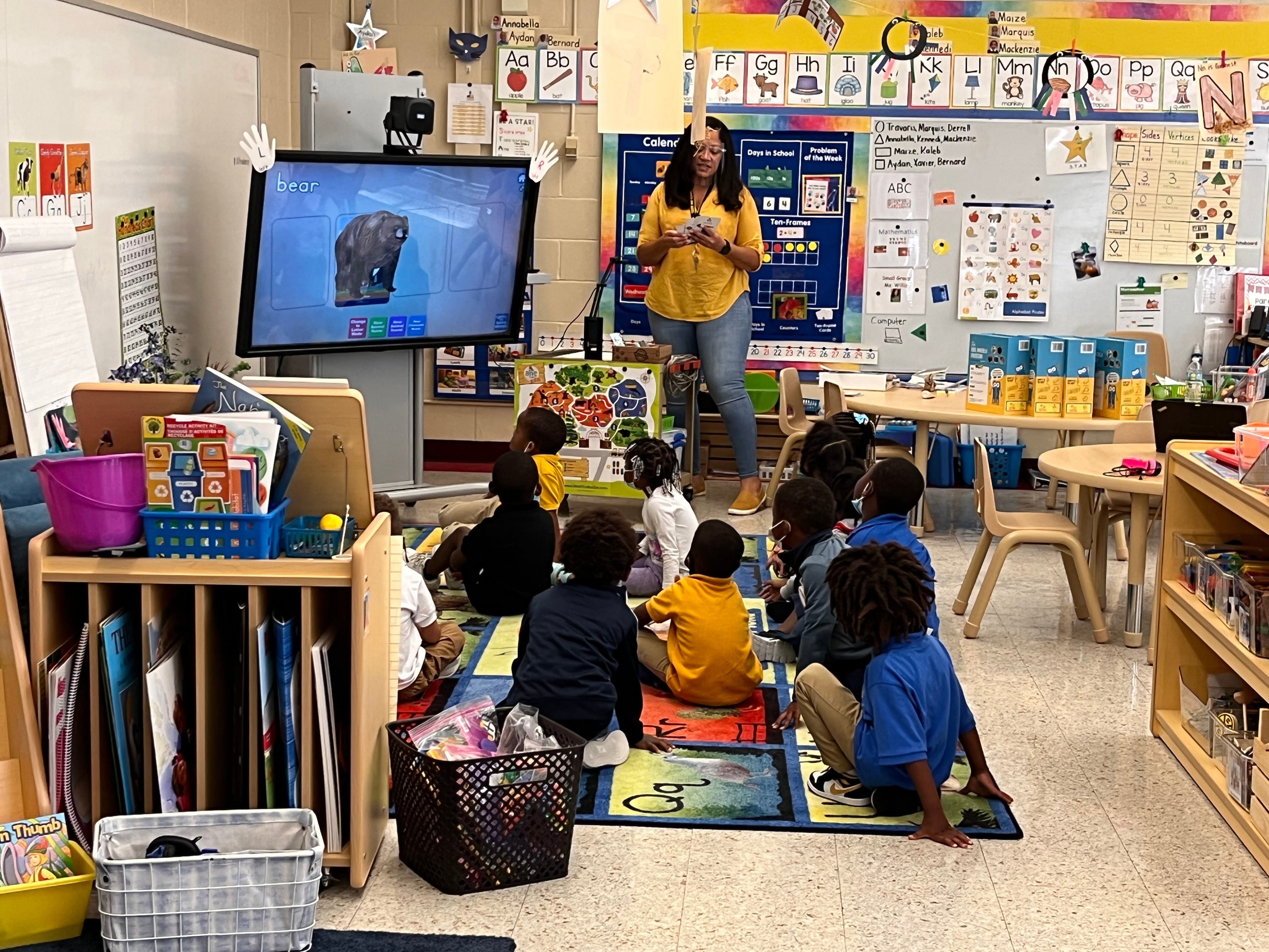 Students interacting with augmented reality at John Love Early Learning Center