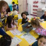 Children in a pre-K class at Flying Colors Learning Center’s East Redd Road location work on letters on Dec. 19, 2022. (Corrie Boudreaux/El Paso Matters)