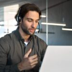 Adult male student is focused on learning difficult german words while sitting at desk