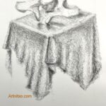 Close-up of drawing hands with graphite stick on white paper