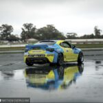 Drifting car sliding sideways on a track, showcasing controlled oversteer