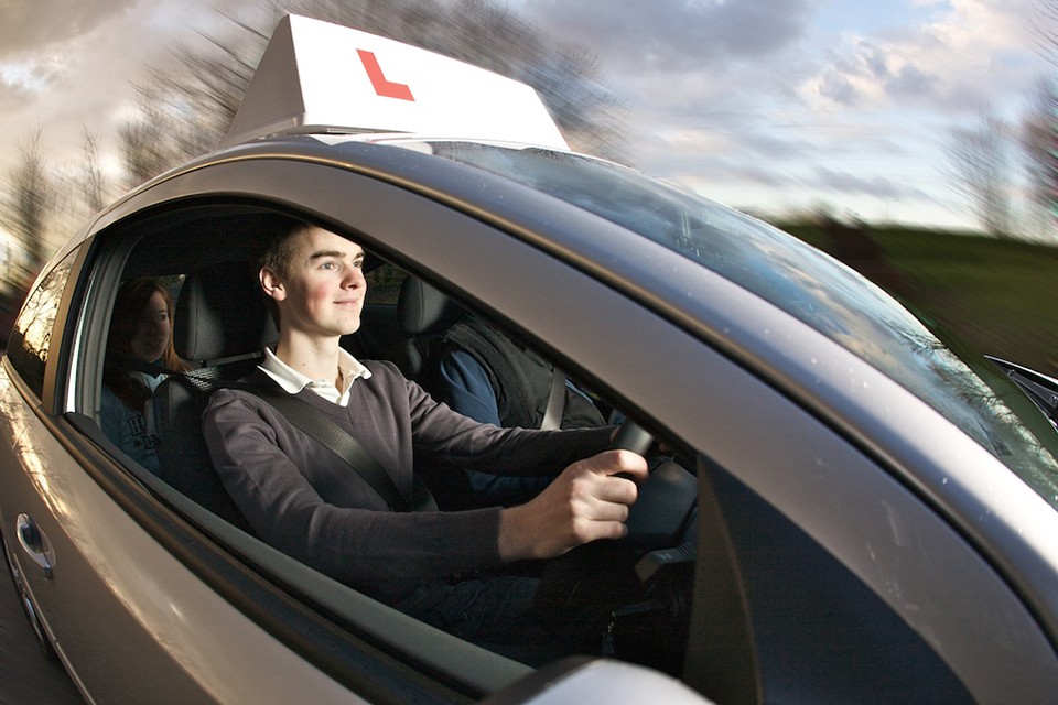Driving instructor demonstrating proper motorway merging techniques