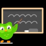 Duolingo Owl holding up a smartphone displaying a language learning lesson.