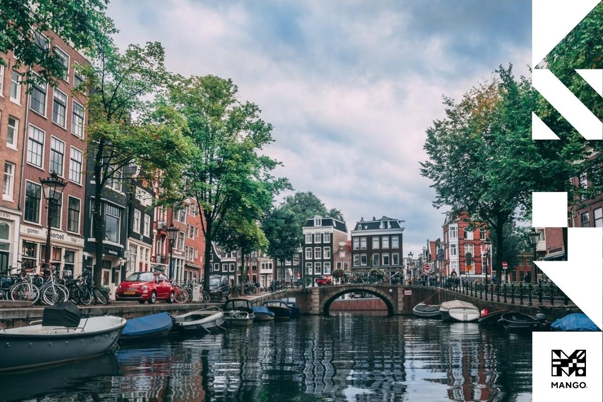 A picturesque Dutch city with canals, cars, bikes, and buildings, highlighting the urban landscape and lifestyle