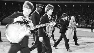 Harrison, Lennon (left) and McCartney (right) walk to the stage at Candlestick Park for the last show of their final tour, August 29, 1966