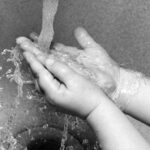 Child Washing Hands at Sink