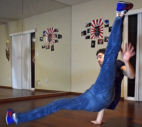 Breakdancer performing a flare, showcasing skill and flexibility