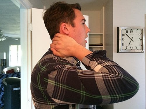 A singer with his hand on the back of his neck