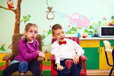 Parent assisting a child with learning, representing teaching children with cerebral palsy learning difficulties