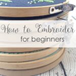 Embroidery supplies essentials for beginners featuring fabric, thread, needles, and hoop