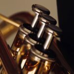 Close up of trumpet valves for a tutorial about how to play the trumpet, demonstrating proper finger placement.