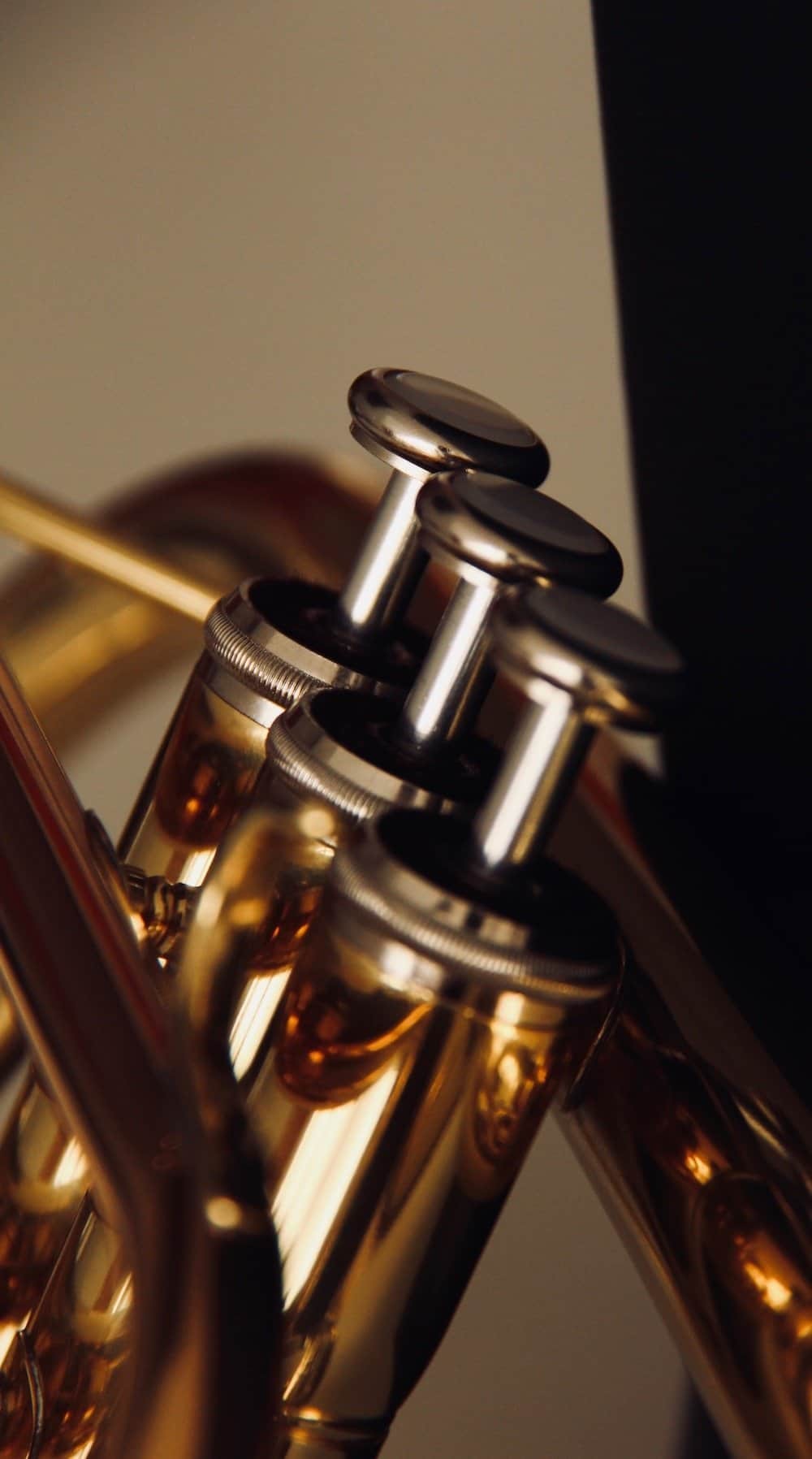 Close up of trumpet valves for a tutorial about how to play the trumpet, demonstrating proper finger placement.