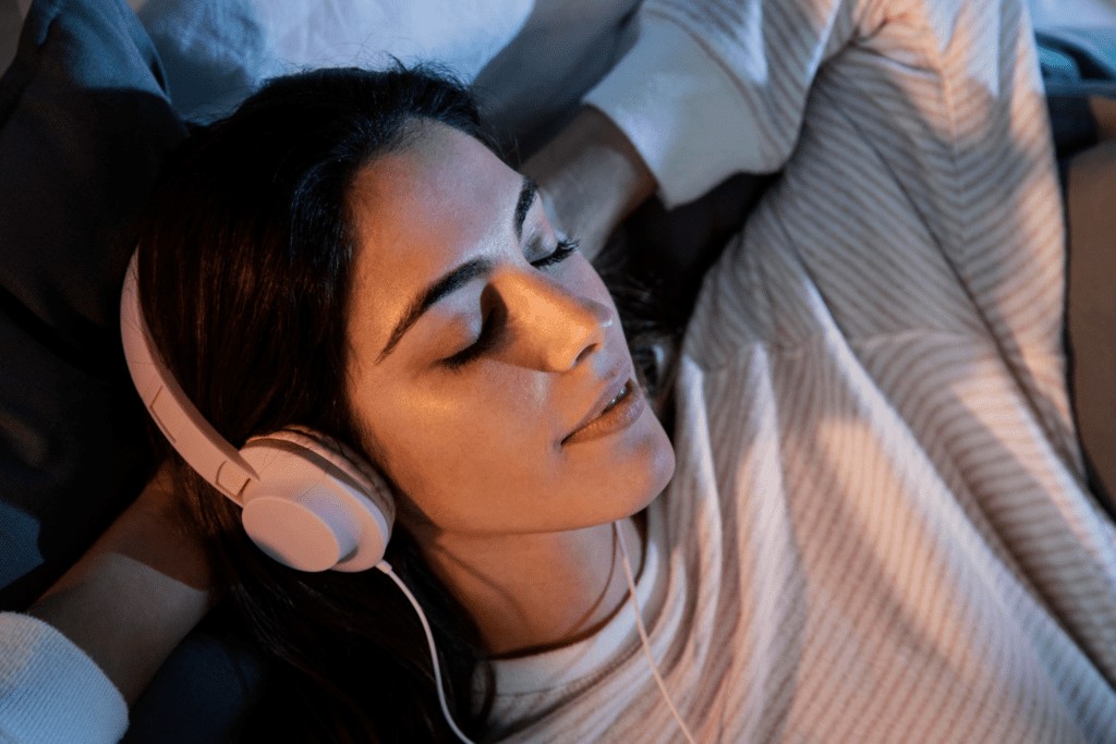Man listening to Spanish lessons with headphones while sleeping