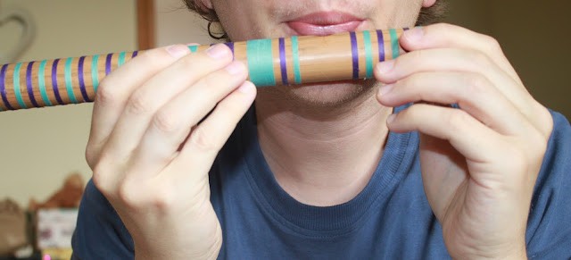 Holding the bamboo flute