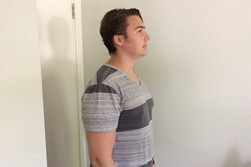 A person standing tall with a straight posture, showcasing ideal singing alignment.