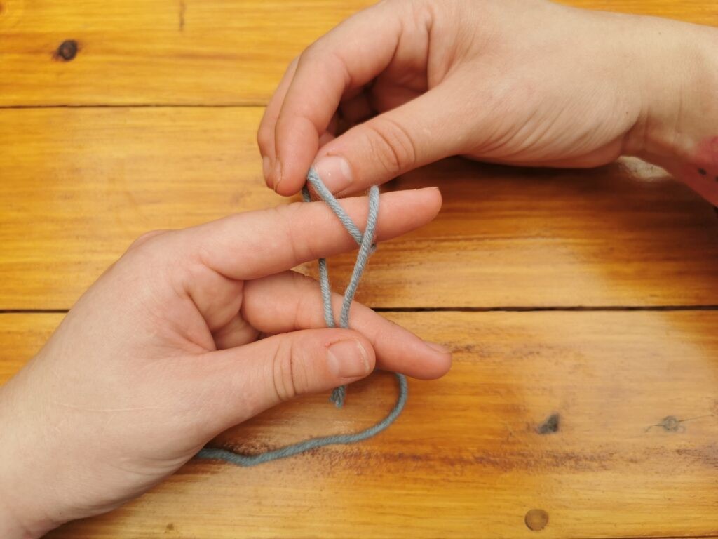 Take the back loop and pull it over the front loop, but don