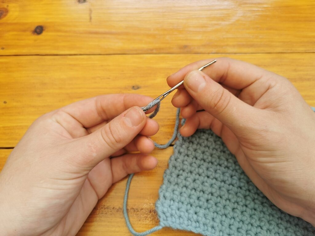 Insert yarn into darning needle