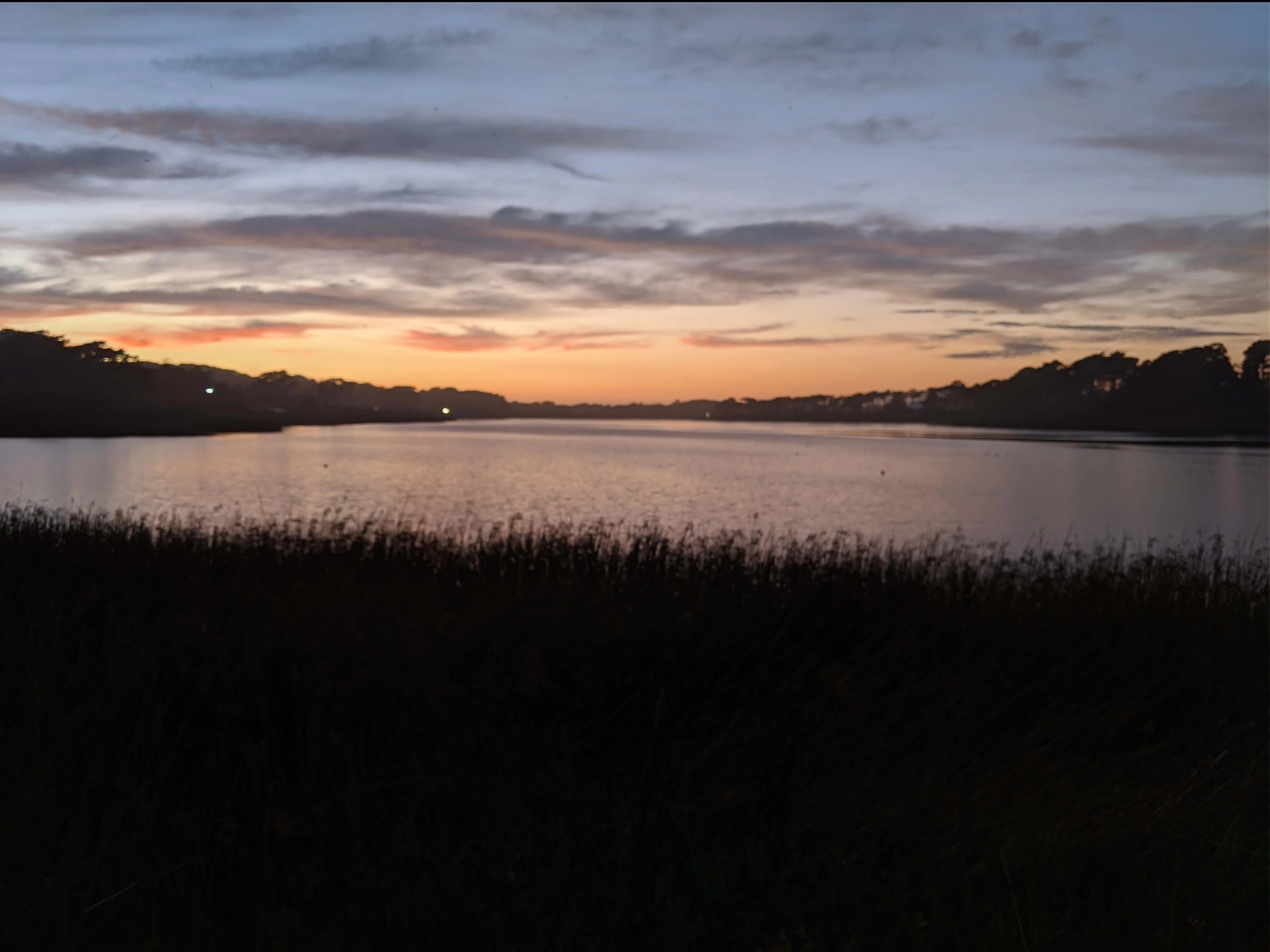 Person meditating by a lake