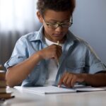 A child struggling to read, with words appearing jumbled and confusing.