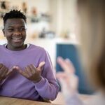 A teenage boy having a conversation using sign language