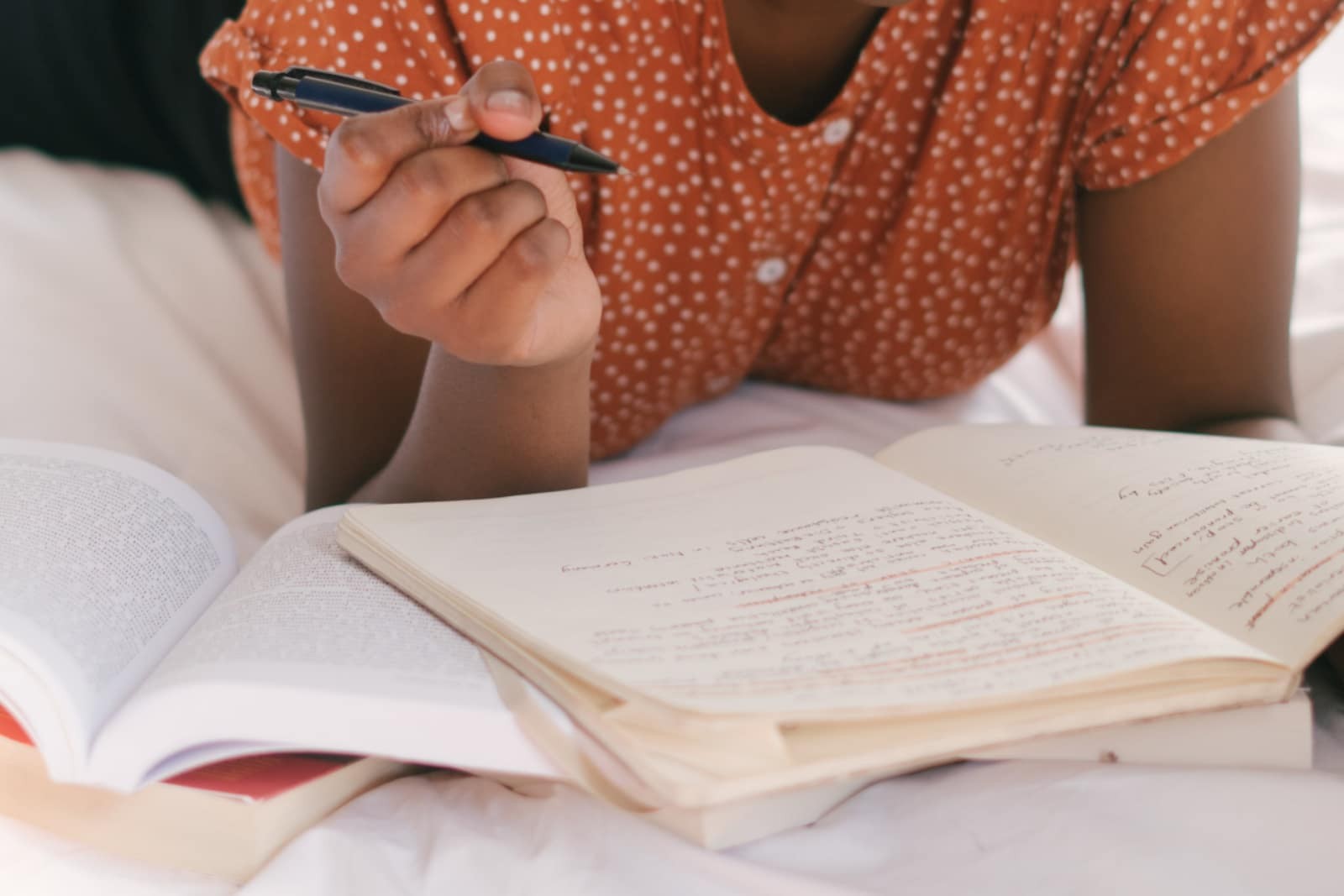 Person writing German words in a notebook, showcasing clear word identification through capitalization of nouns and identifiable verb endings
