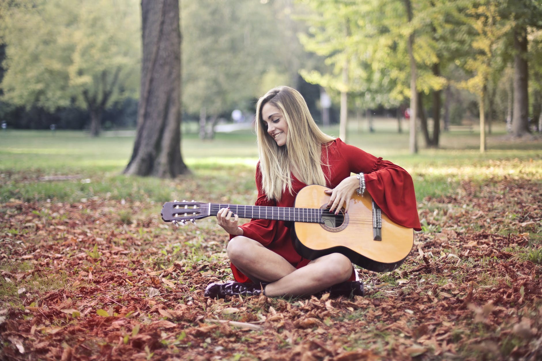 Close-up shot of a person playing a classical guitar.