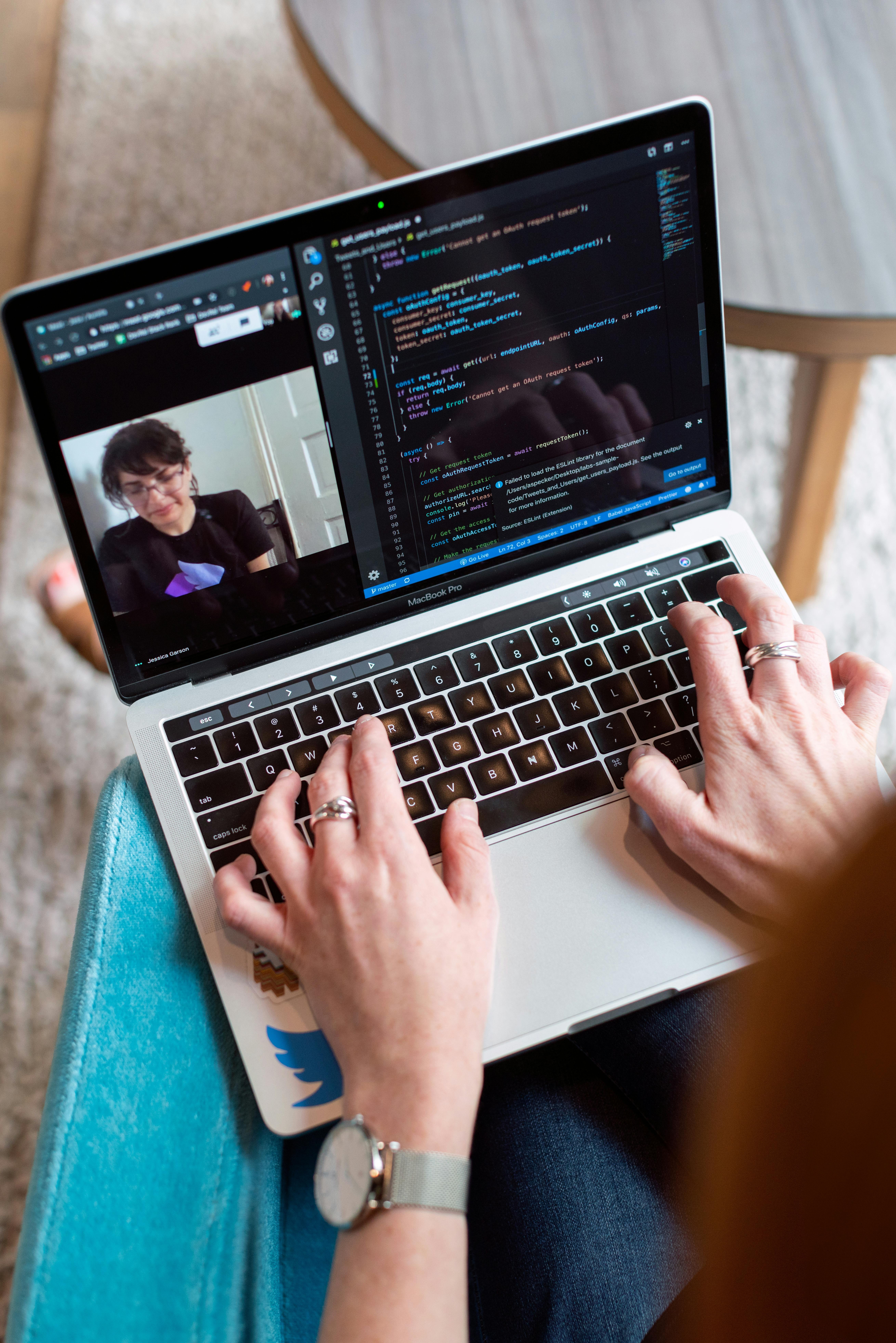 Person using laptop, possibly watching Khan Academy tutorials