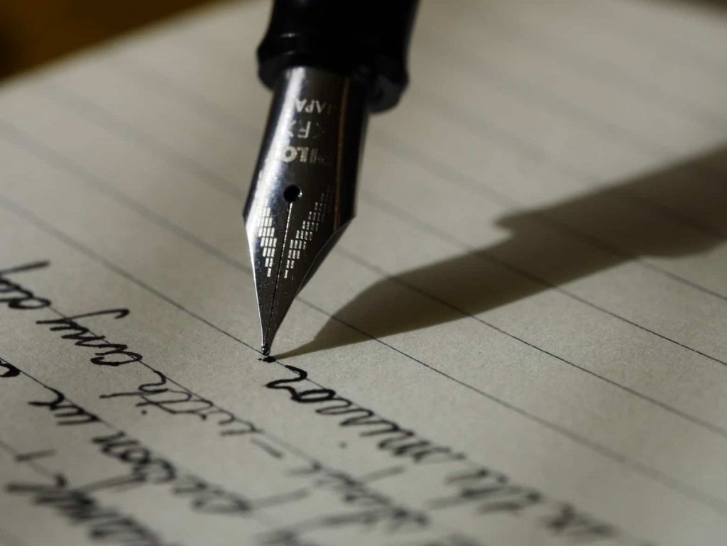 Person writing with a larger vocabulary showcasing the importance of language