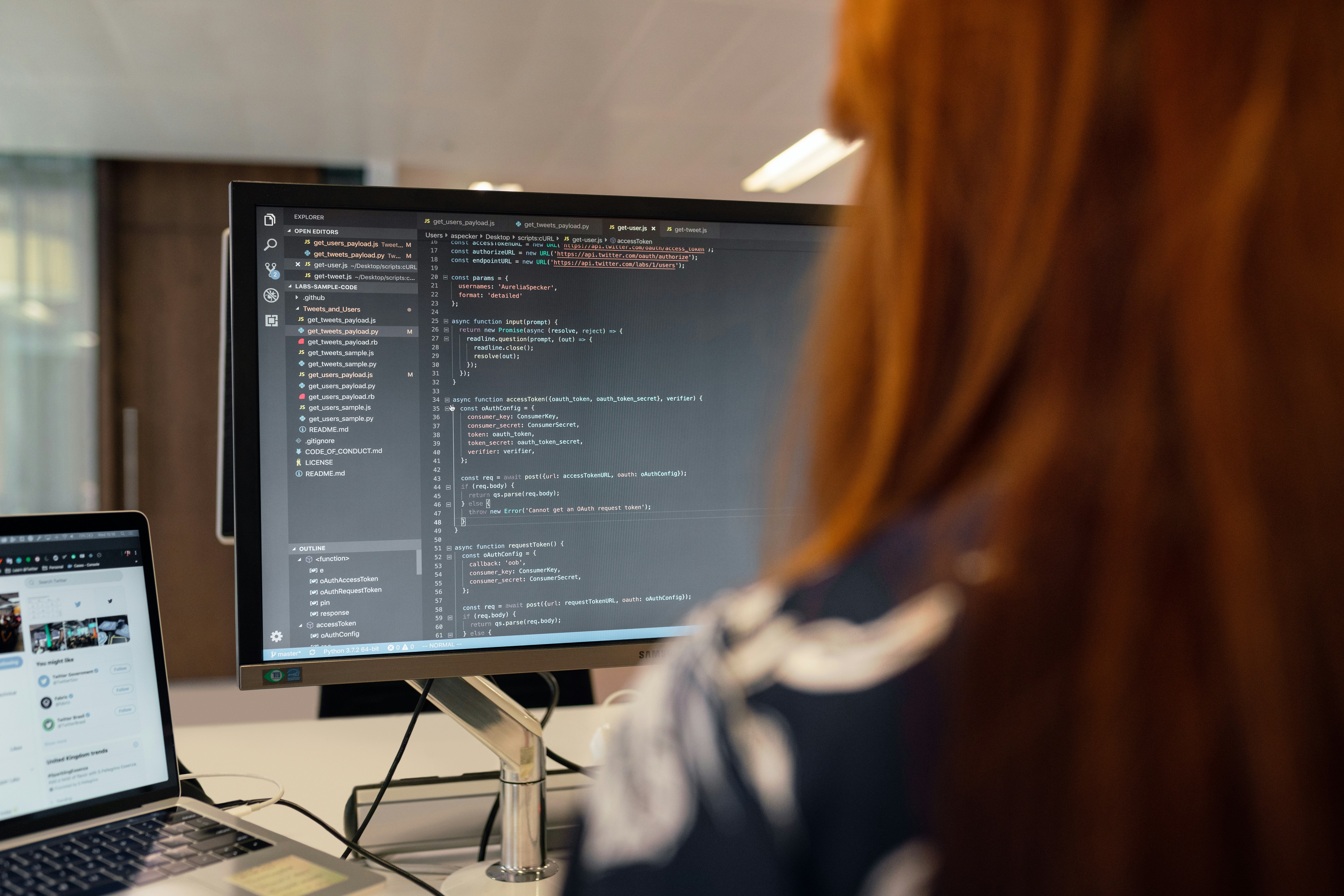 Woman using laptop at desk, focused on Codecademy interface
