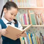 Child engrossed in a colorful book