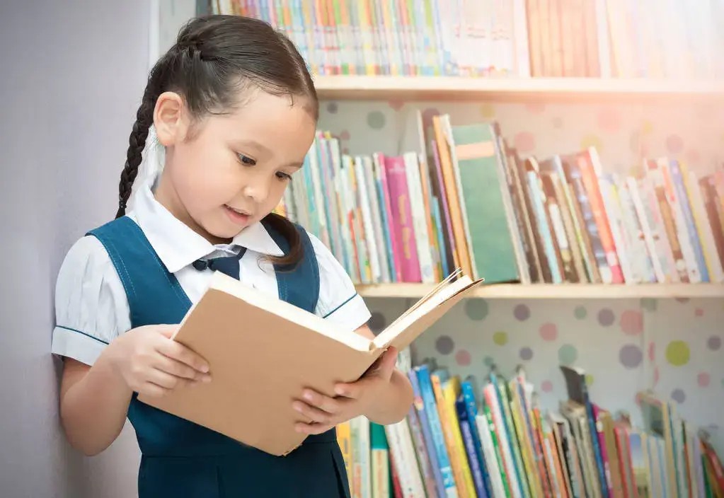 Child engrossed in a colorful book