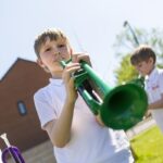 Children playing pTrumpet with Durham Brass