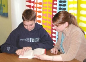 A young girl engrossed in a book, illustrating the joy and importance of reading from an early age.