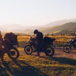 Motorcycle rider leaning into a turn on a scenic road