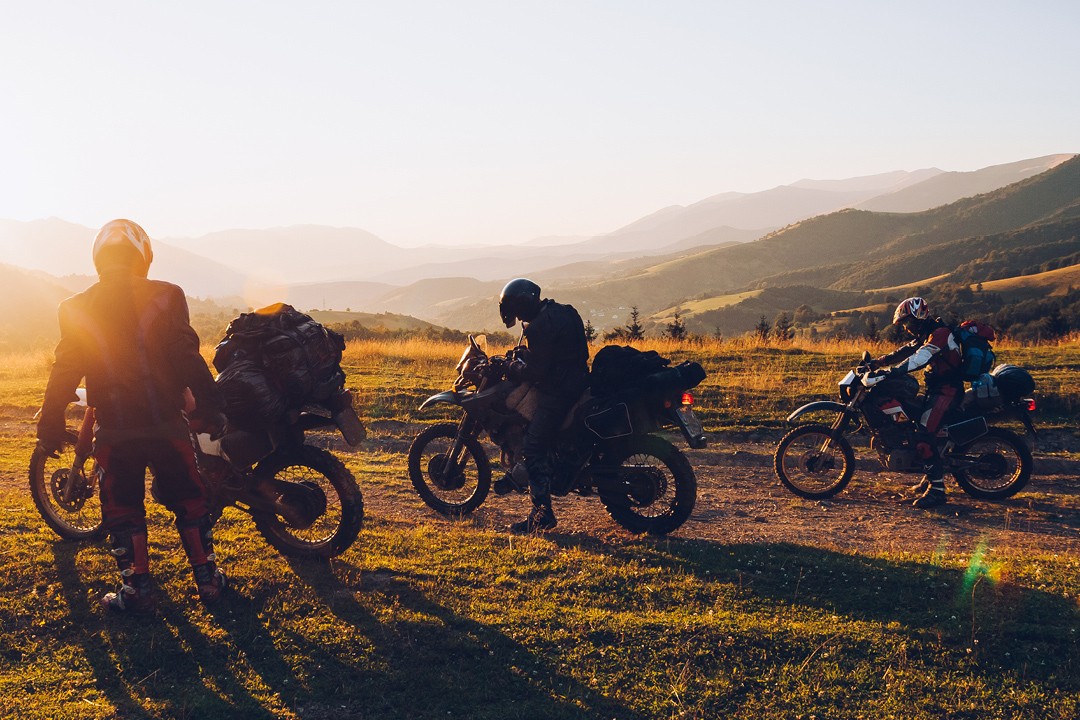 Motorcycle rider leaning into a turn on a scenic road