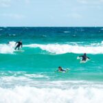 Surfing beginner's journey, focusing on balance and paddle techniques