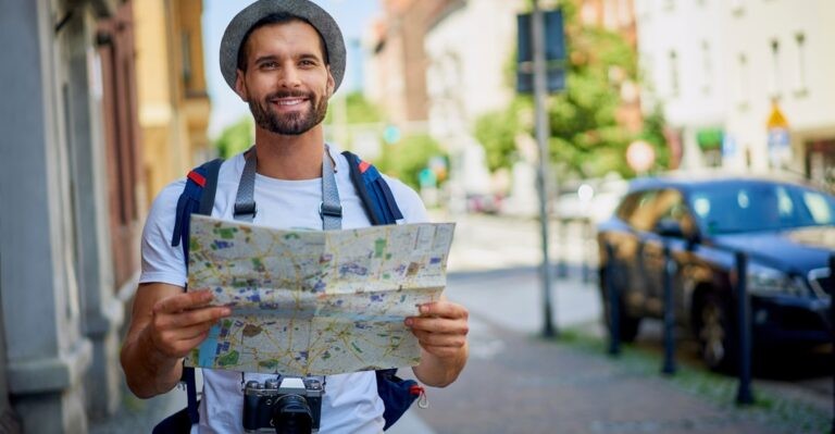 Male tourist with map practicing his Spanish vocabulary for travel