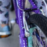 Child riding a bike with training wheels on a sunny day
