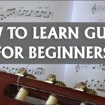 Close-up of a beginner learning basic guitar chords, focusing on finger placement and technique