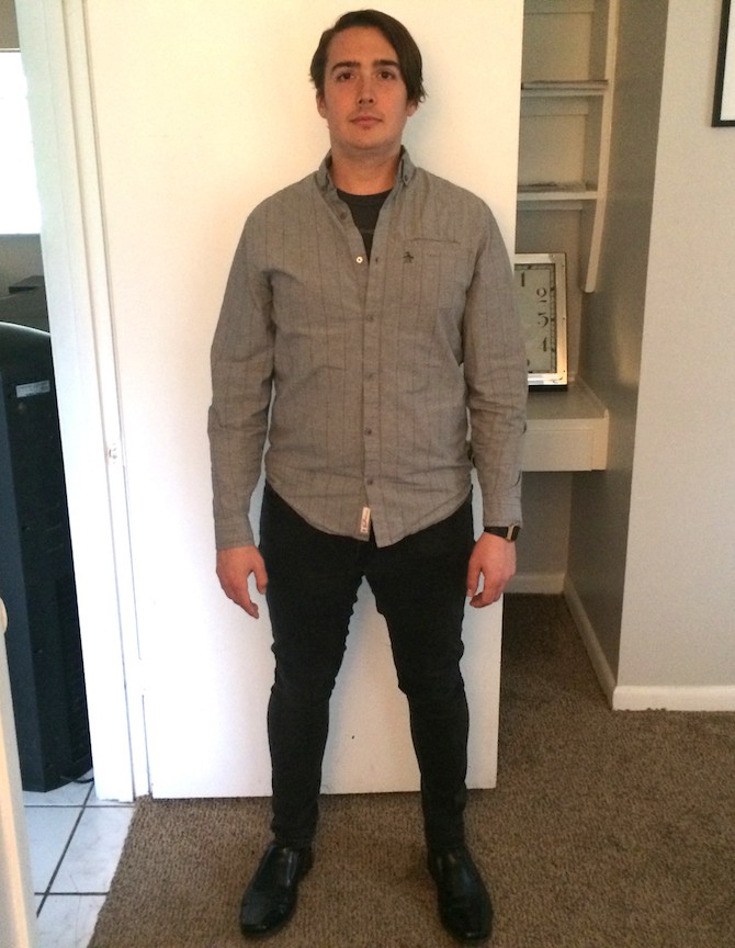 Man standing with tall posture in front of a door