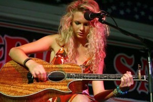 Young Taylor Swift learning guitar with her mother nearby