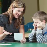 Teacher assisting a student with reading difficulties