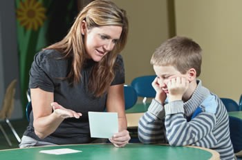 Teacher assisting a student with reading difficulties