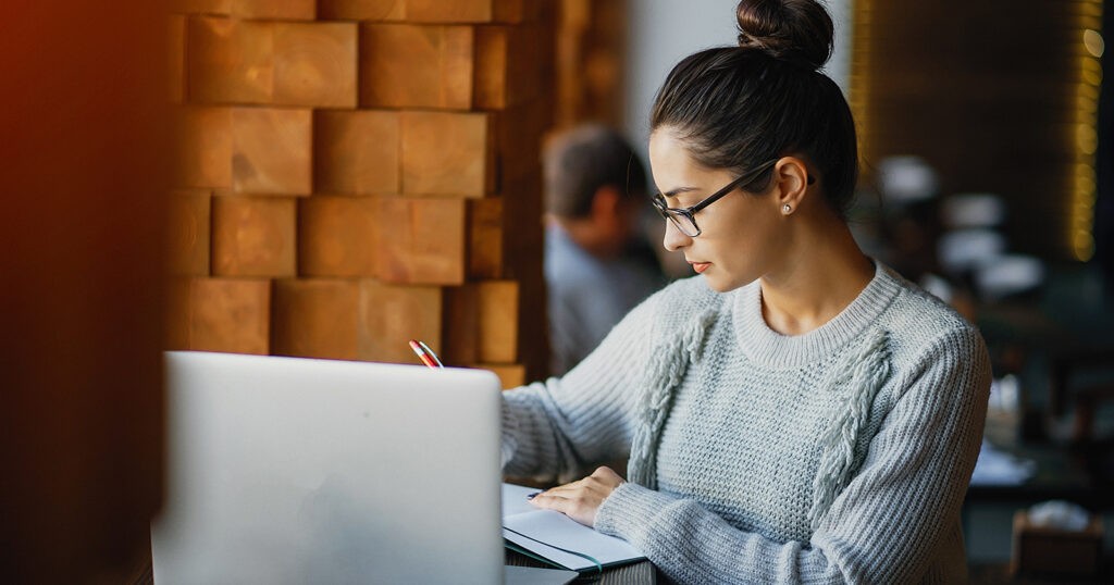 woman learning accounting alone laptop