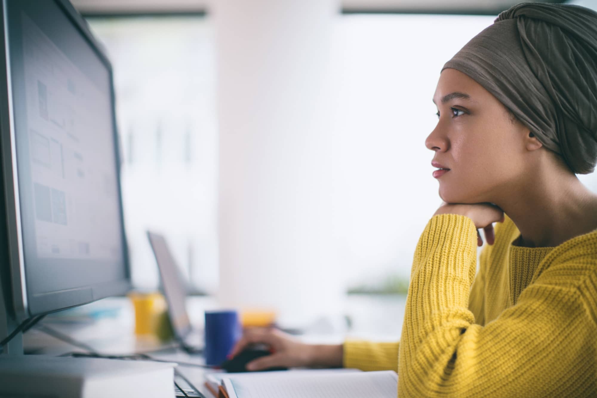 Woman working on a desktop computer in an office