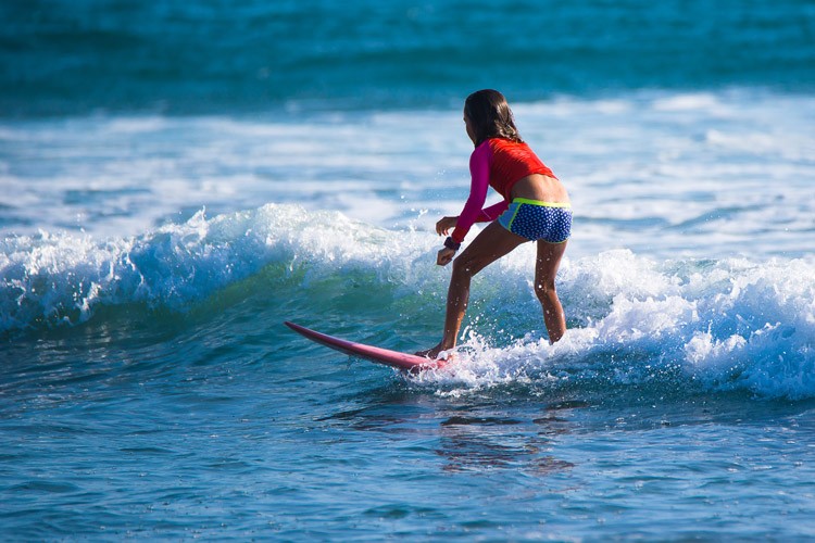 Surfer riding a wave, demonstrating balance and skill